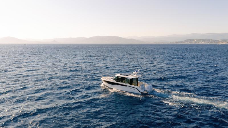New Yamarin Aura Cabin driving northwest in a sea. Distant shoreline is visible.
